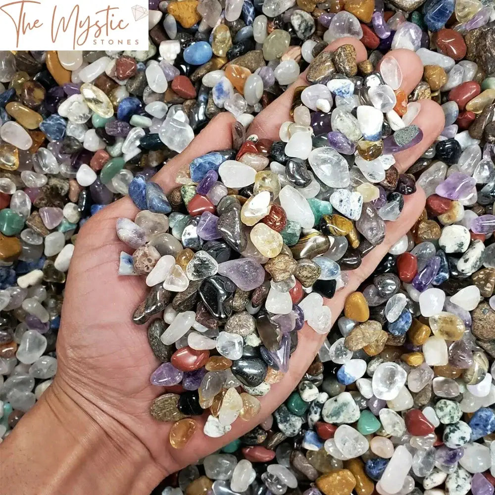 A collection of variously colored tumbled crystal chips, showcasing an assortment of natural stones.