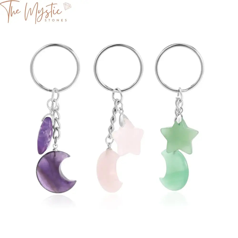 A silver-colored keychain featuring a healing natural stone bead pendant with trendy moon and star charms attached.