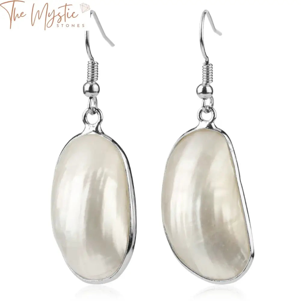 Close-up image of a pair of elegant drop earrings featuring natural mother of pearl shell cabochons.