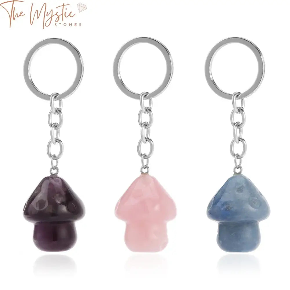 A collection of mushroom-shaped crystal pendants attached to a stainless steel key ring, featuring various natural stones.