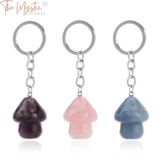 A collection of mushroom-shaped crystal pendants attached to a stainless steel key ring, featuring various natural stones.