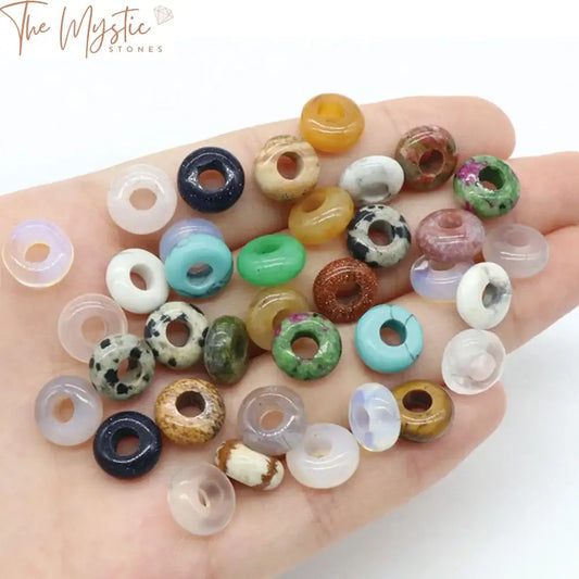 A collection of 20 natural stone agate beads, each shaped like a large-holed abacus donut.