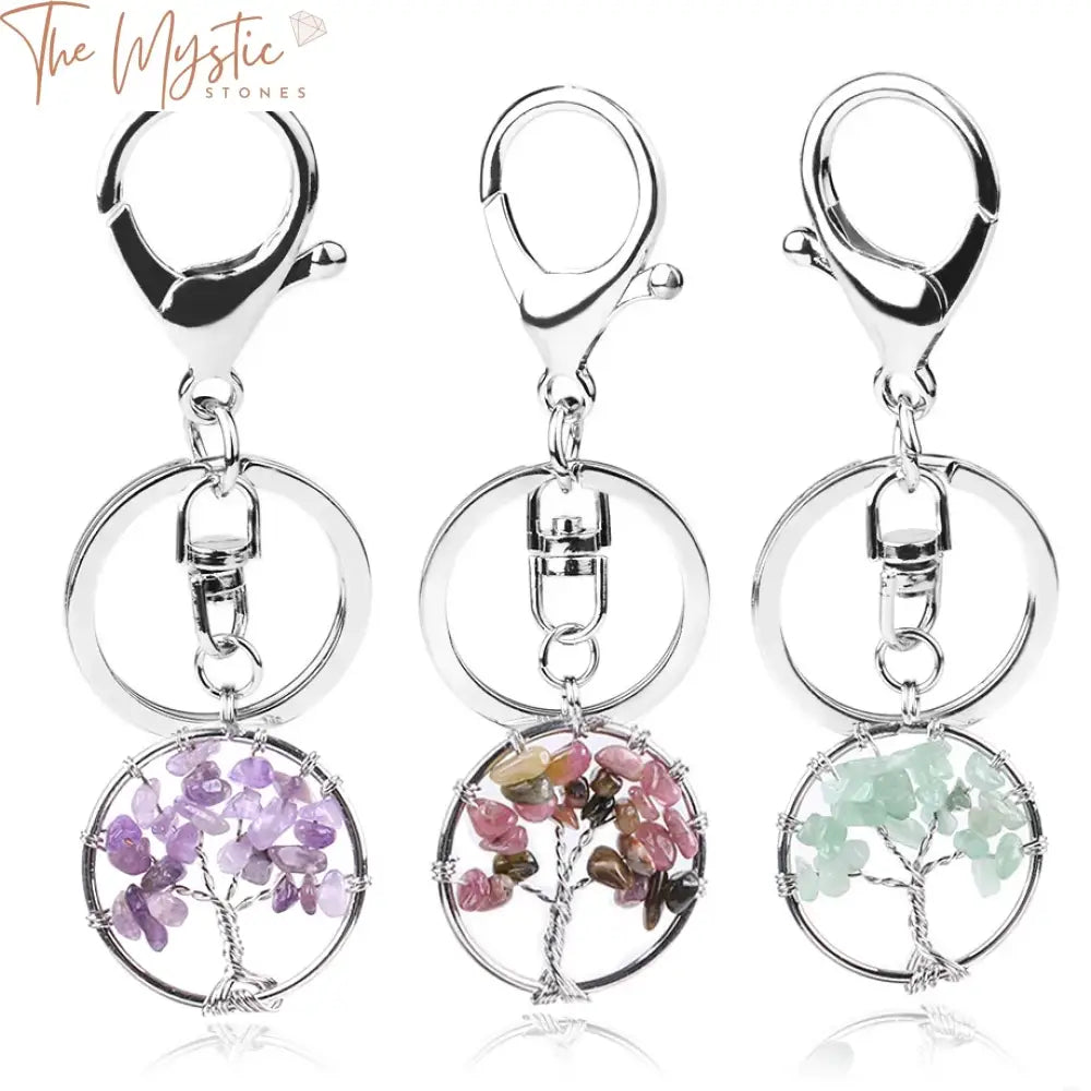 A collection of keychains featuring round pendants made from natural crystal stones.