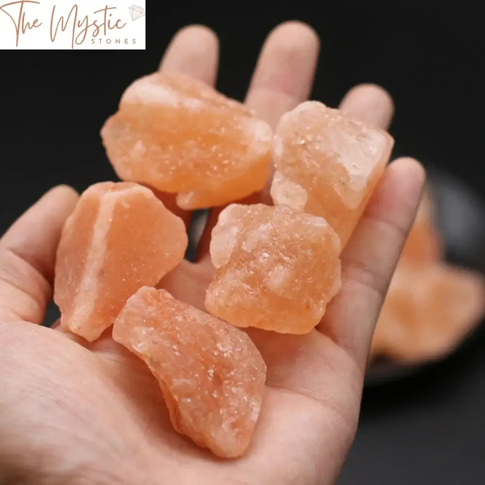 A collection of rough, natural orange salt stones of varying sizes, showcasing their textured surfaces.