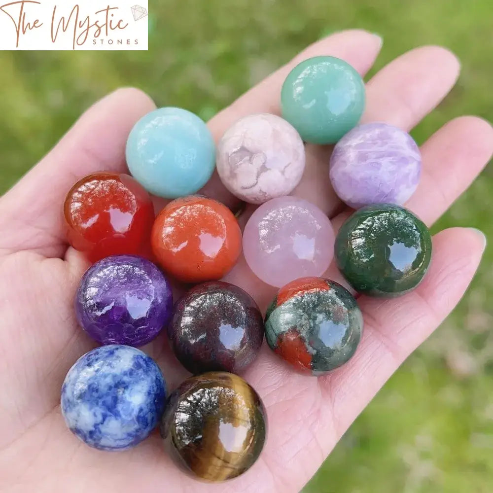 A collection of assorted 20mm polished natural quartz spheres in various colors and patterns, displayed on a wooden surface.