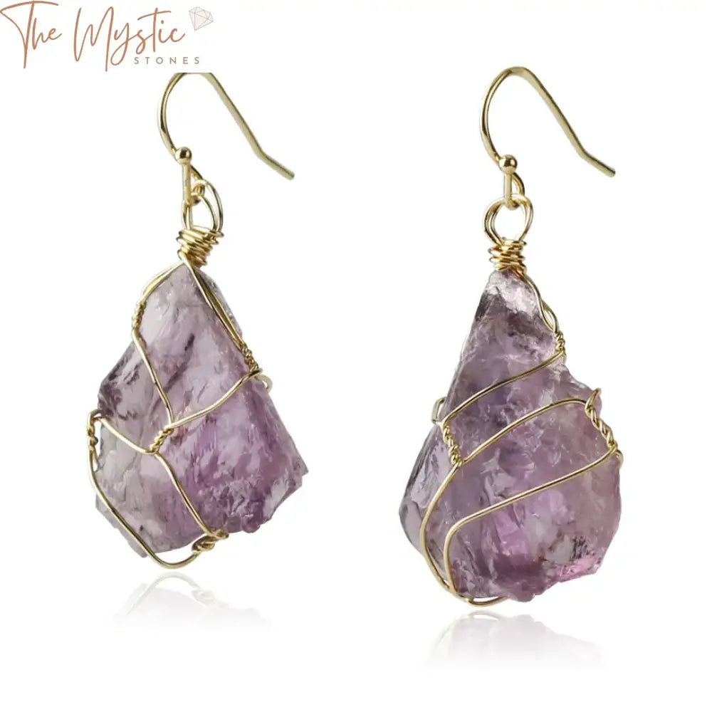 A pair of irregularly shaped natural stone drop earrings, each wrapped in gold-colored wire with an asymmetric design.