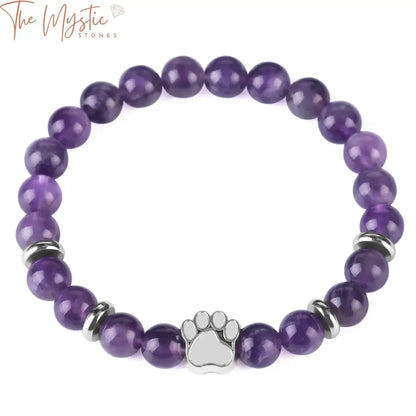 A close-up image of a beaded bracelet featuring a combination of purple crystal beads and matte black lava stones.