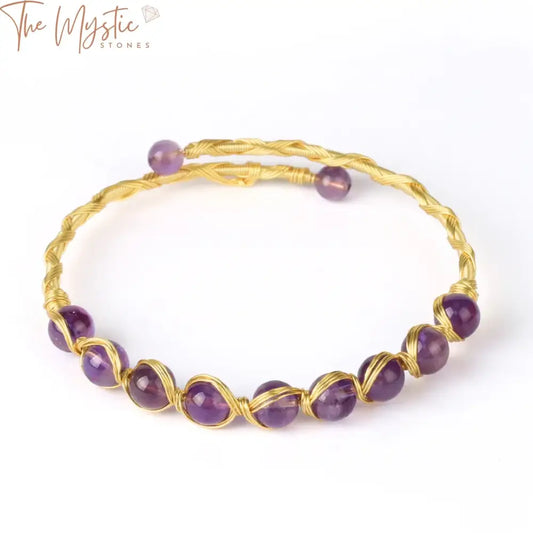 A gold-colored open cuff bangle bracelet for women, featuring round natural stone beads.