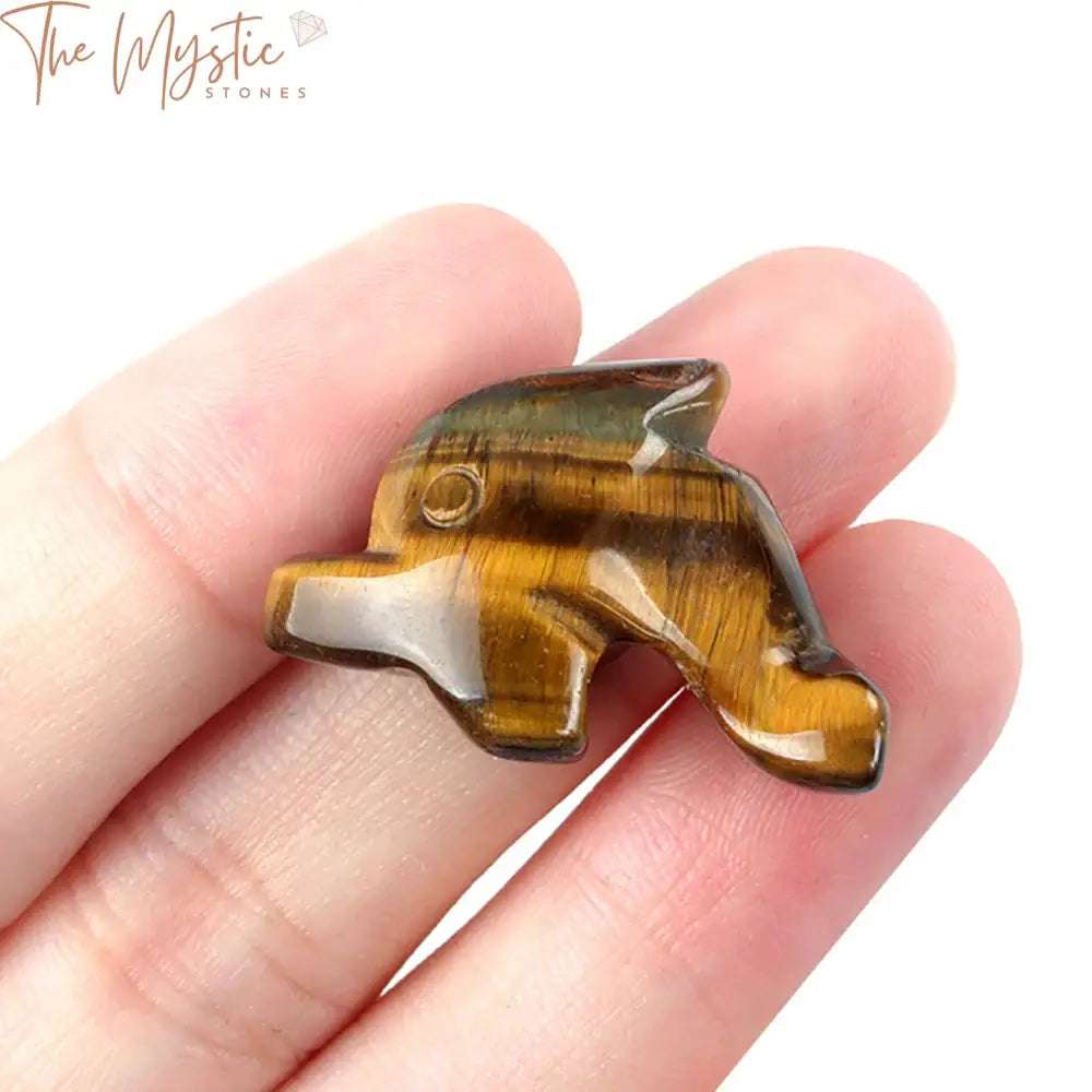 A 1-inch hand-carved dolphin figurine made from natural stone, showcasing intricate details.