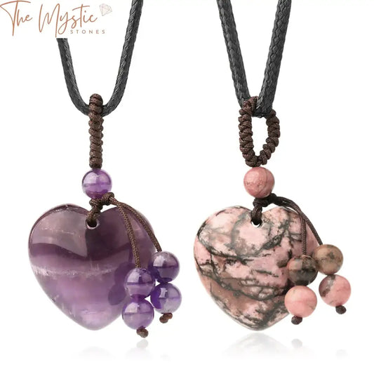 A collection of heart-shaped pendants made from natural stone, featuring a vibrant purple crystal sodalite.