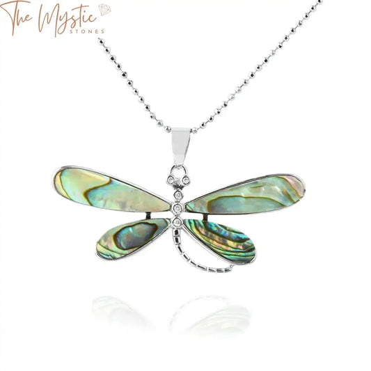 A collection of dragonfly pendants crafted from natural abalone shell, each with intricate details.