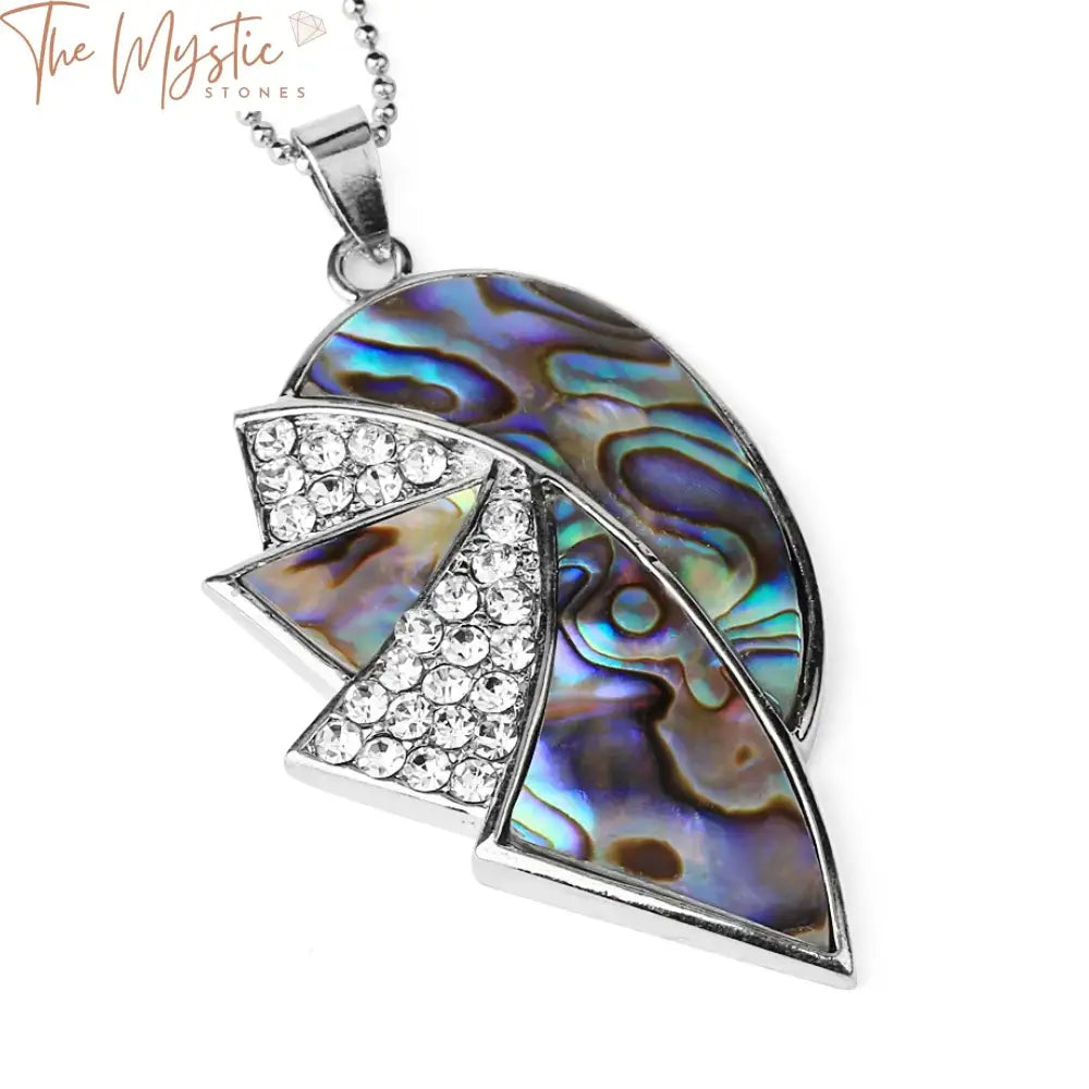 A vibrant New Zealand abalone shell pendant featuring a geometric design.