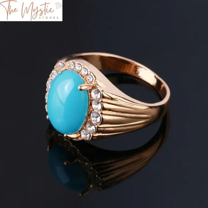 A vintage-style gold ring featuring a large, oval-shaped blue turquoise stone as its centerpiece.