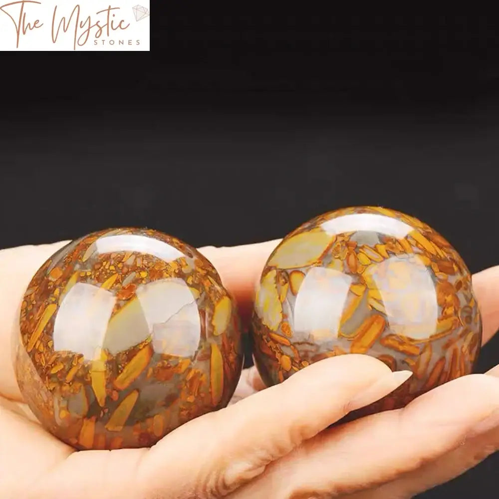 A pair of 50mm natural polished Nuwa stone crystal balls, smooth and shiny with a light translucence, placed side by side.