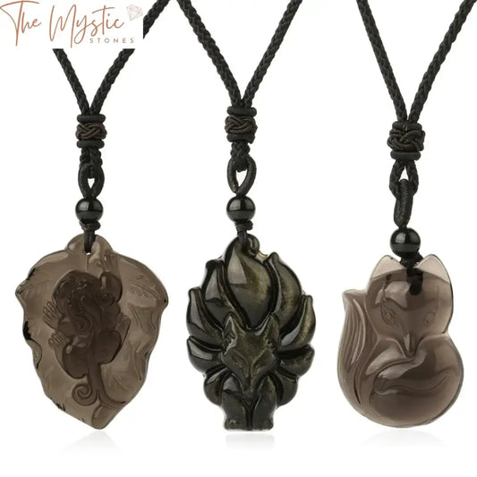 A close-up image of a black obsidian necklace featuring a detailed carving of a nine-tailed fox.