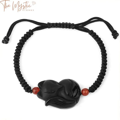 A bold men's bracelet featuring natural obsidian stones, intricately woven into a black rope.