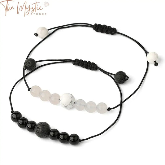 A close-up image of a stylish bracelet featuring polished black and white agate beads.