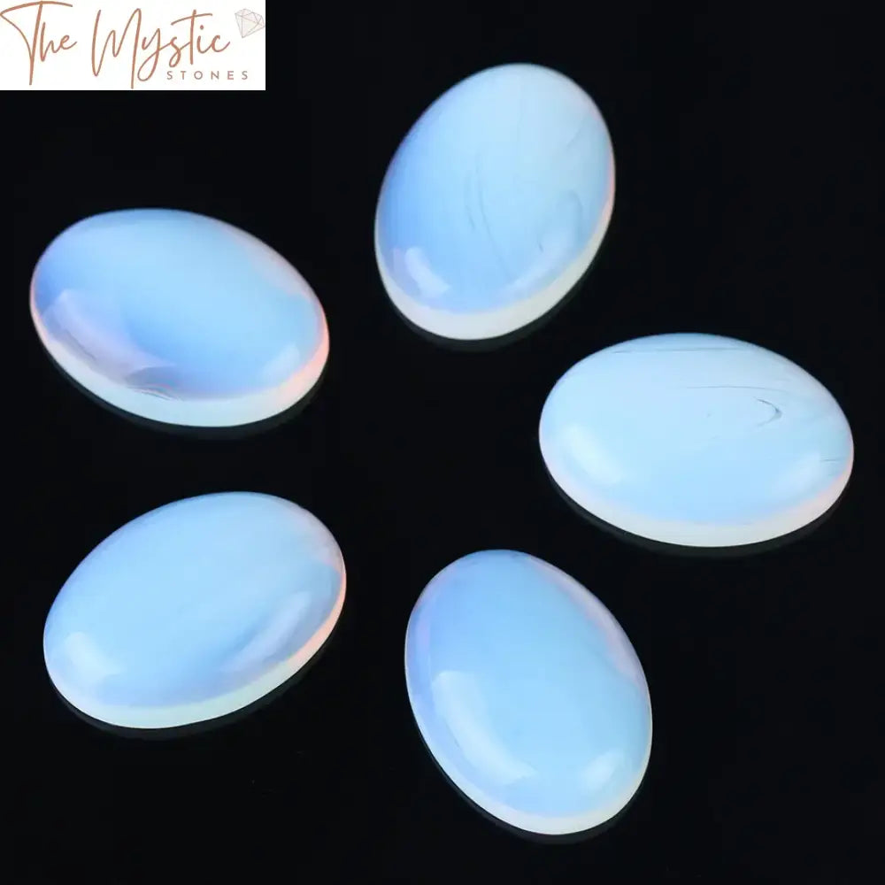 A collection of shiny, multi-colored opal beads in dome and oval flat-back shapes, displayed on a plain background.