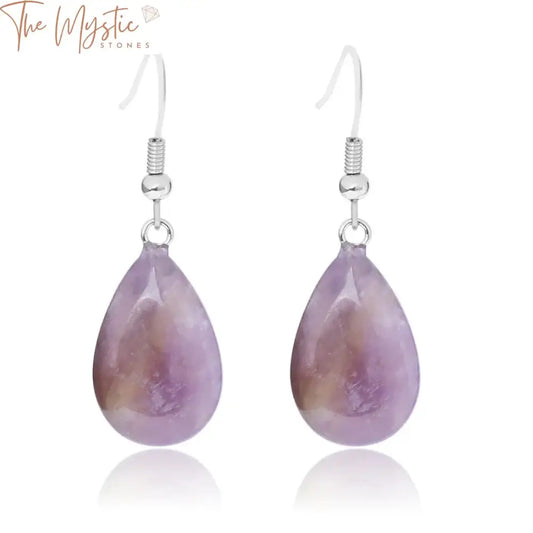 A pair of handmade earrings featuring teardrop-shaped opal crystals with a glossy glaze.