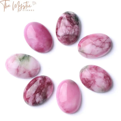 A collection of colorful, oval-shaped natural loose gemstone beads displayed against a plain white background.