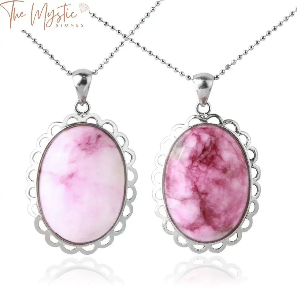 A natural stone oval pendant necklace featuring a smooth, polished pink crystal cabochon.