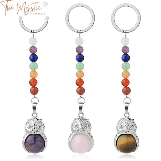 A vibrant owl keychain featuring a cute owl design, adorned with natural stones representing the 7 chakras.