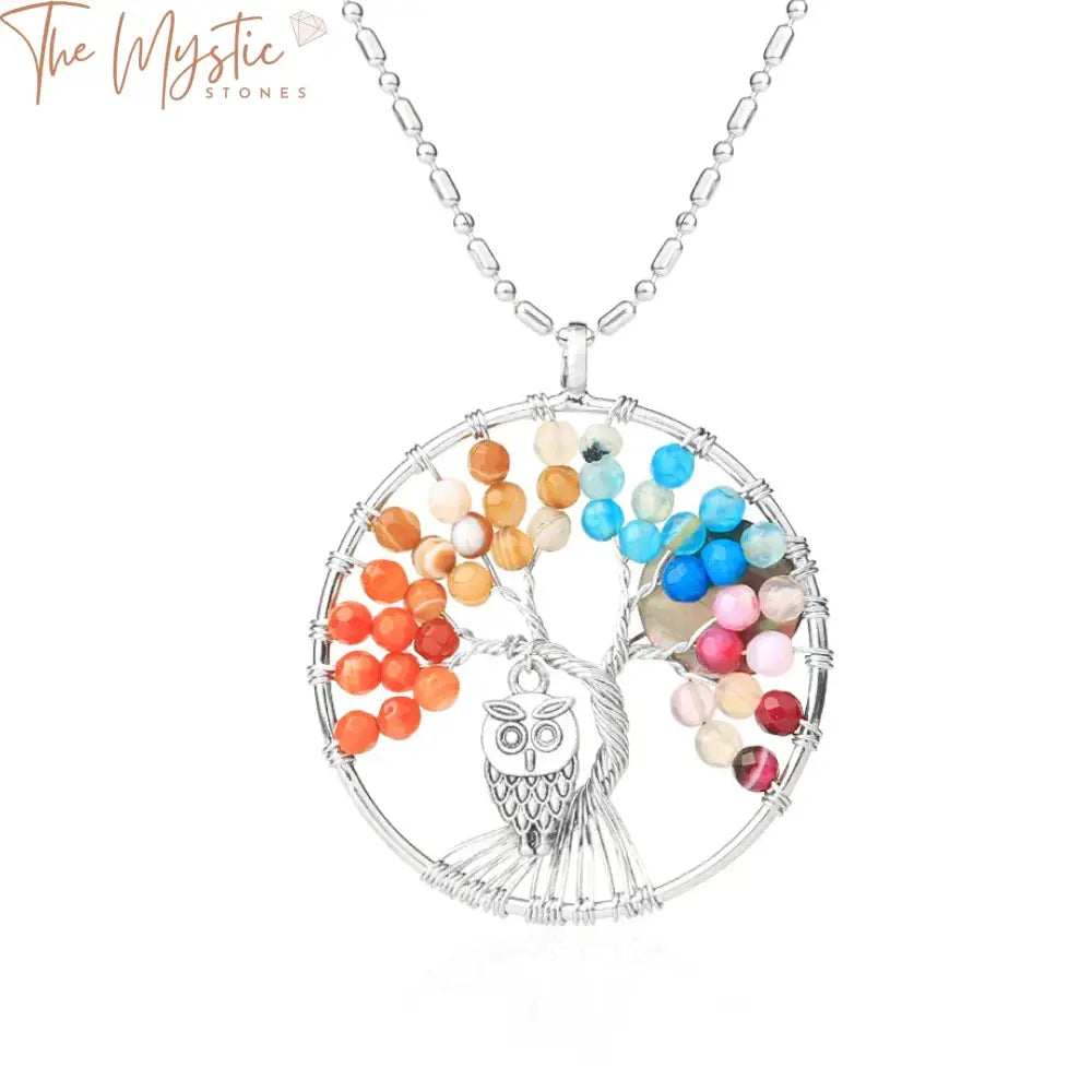 A 7 Chakra Tree of Life pendant necklace featuring vibrant, faceted natural agate beads in various colors.