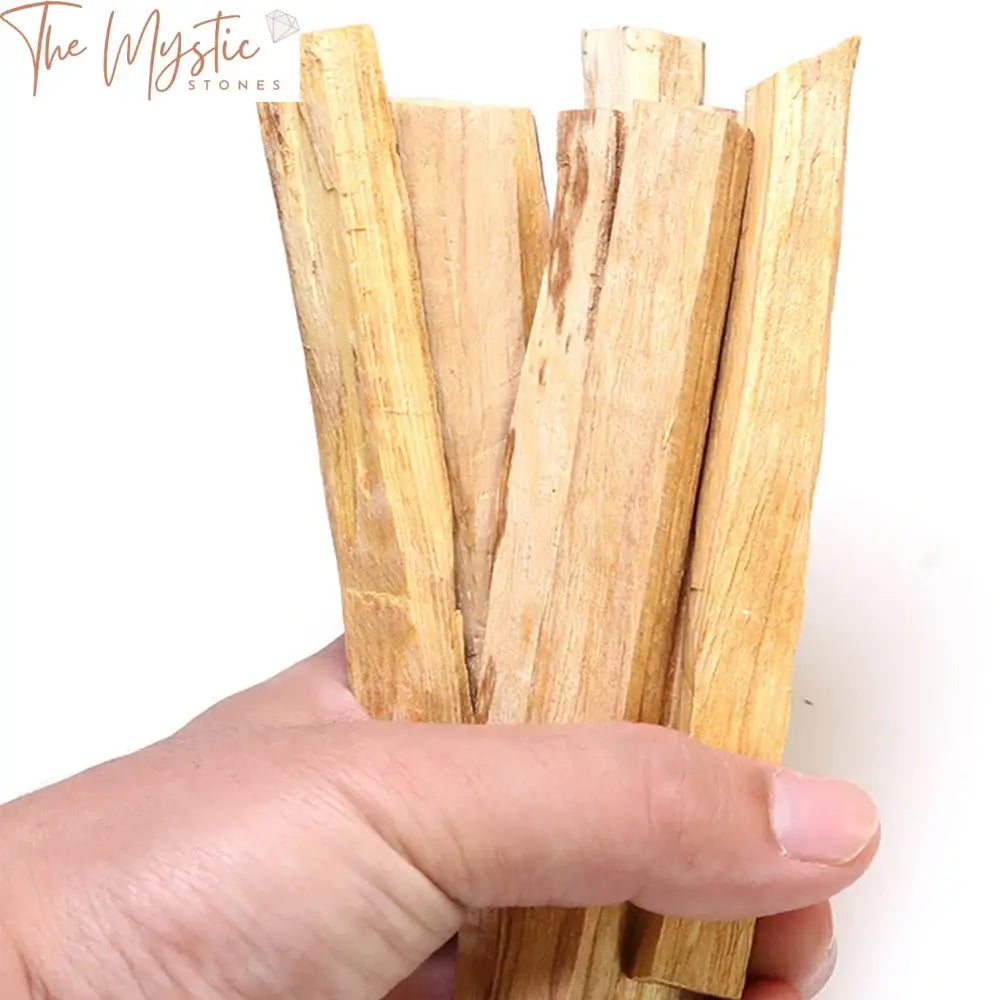 A single Palo Santo wood stick, measuring approximately 8-11cm, rests on a flat surface.