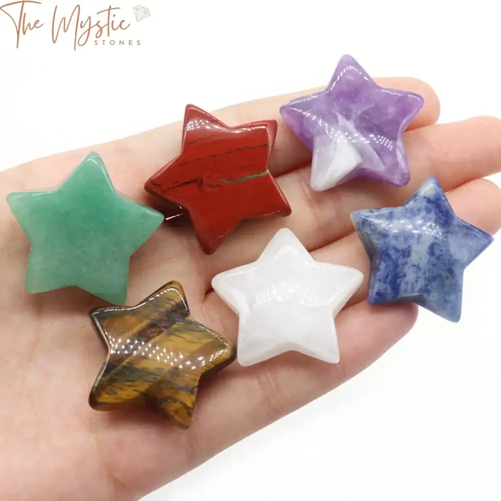 A set of polished natural chakra stones arranged in a star-shaped pentagram formation, each stone approximately 30mm in size.