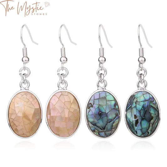 A pair of egg-shaped dangle drop earrings made from pink and white abalone shell.