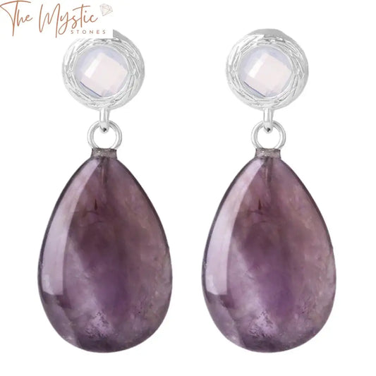 A pair of earrings featuring water drop-shaped pink crystal beads at the center, designed in a stud style.