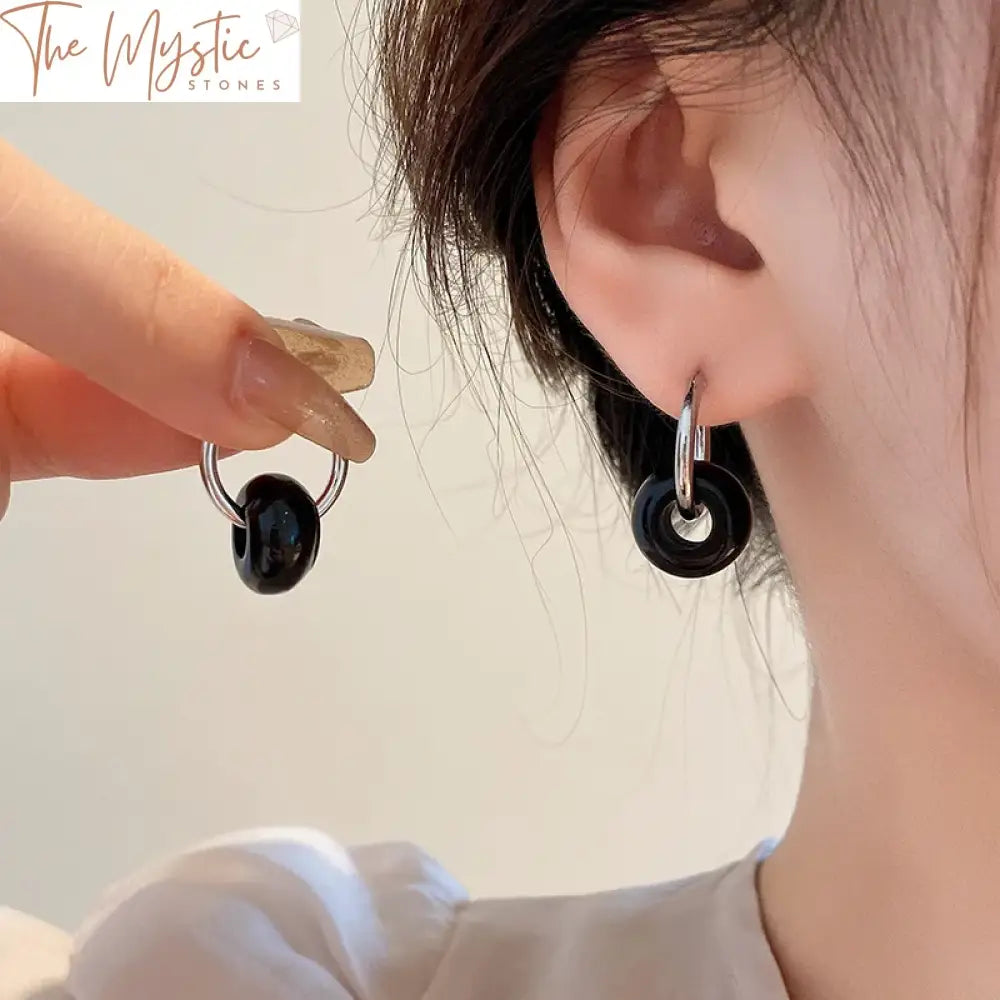 A pair of natural stone earrings featuring pink quartz and tiger eye donut stones.