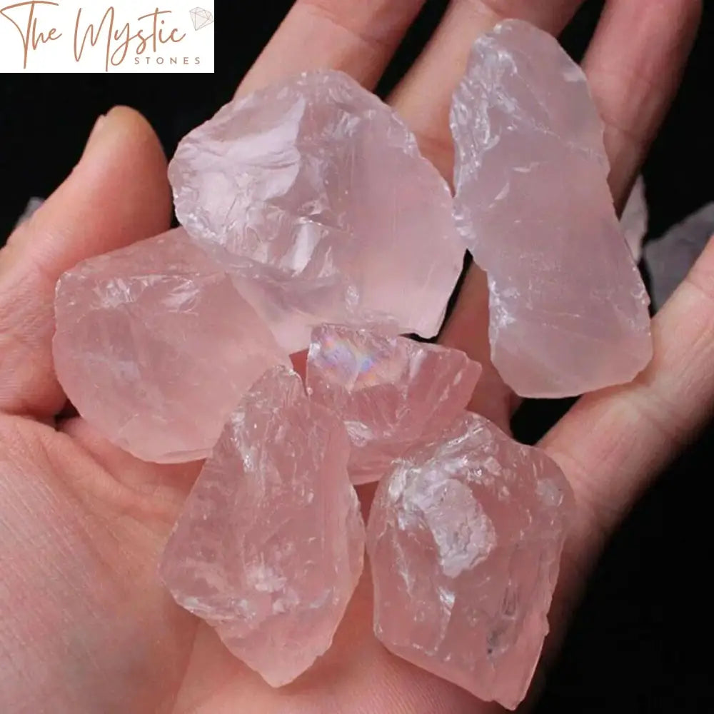 A roughly textured, unpolished pink rose quartz crystal sits against a plain background.