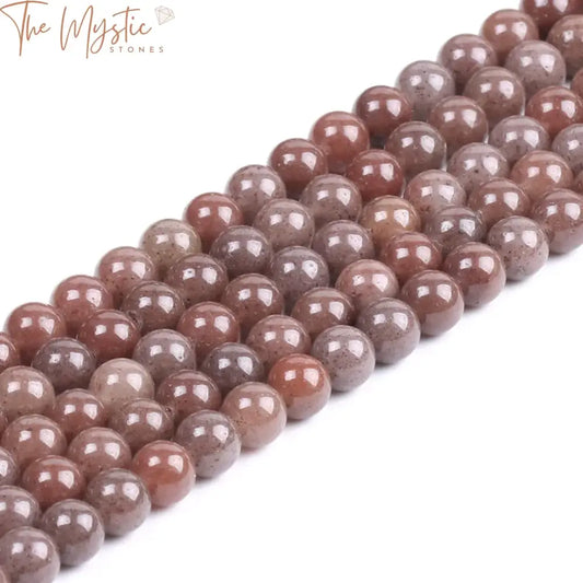 A collection of smooth, polished purple aventurine gemstone beads.