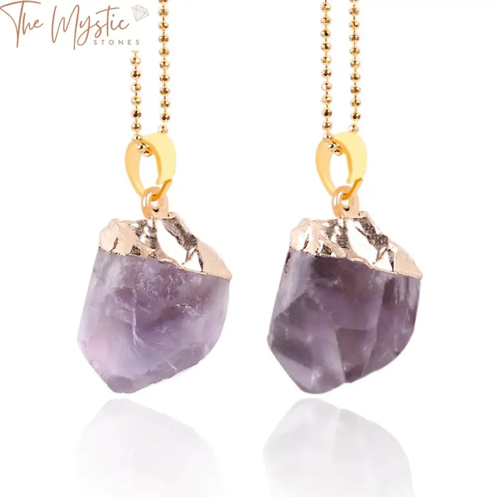 A collection of gold-colored necklaces and pendants featuring natural purple crystal quartz stones.