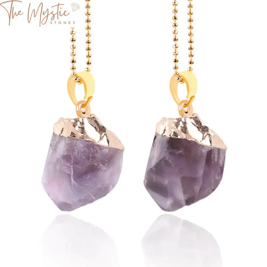 A collection of gold-colored necklaces and pendants featuring natural purple crystal quartz stones.