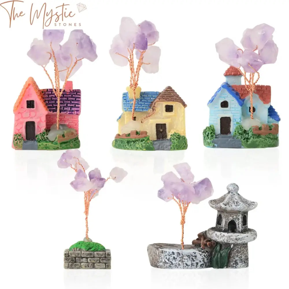 A miniature fairy garden scene featuring a small, whimsical villa house adorned with intricate details.