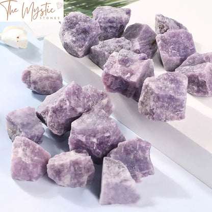 A rough, natural purple Lepidolite stone with a rich, deep violet hue is displayed prominently.