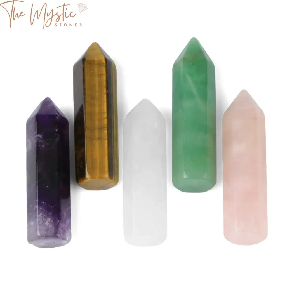 A collection of smooth, hexagonal wand-shaped crystals displayed on a soft, neutral background.