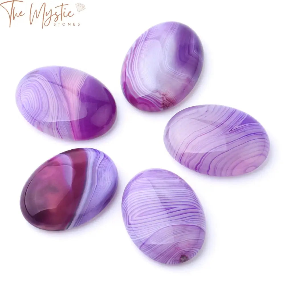 A selection of smooth, oval-shaped purple striped agate cabochons with no holes.