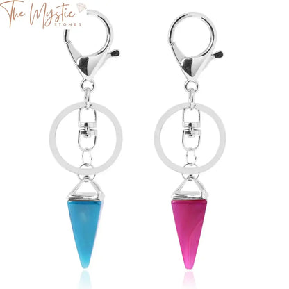 A collection of keychains featuring pyramid-like charms made from natural stone, specifically pink quartz and green stones.