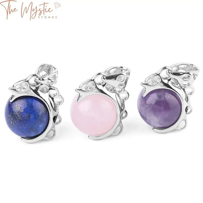 A collection of round ball bead pendants made from natural stones, including pink quartz, purple crystal, and lapis.