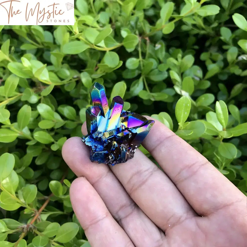 A vibrant cluster of natural quartz crystals with a rainbow titanium sheen, displaying a range of iridescent colors.