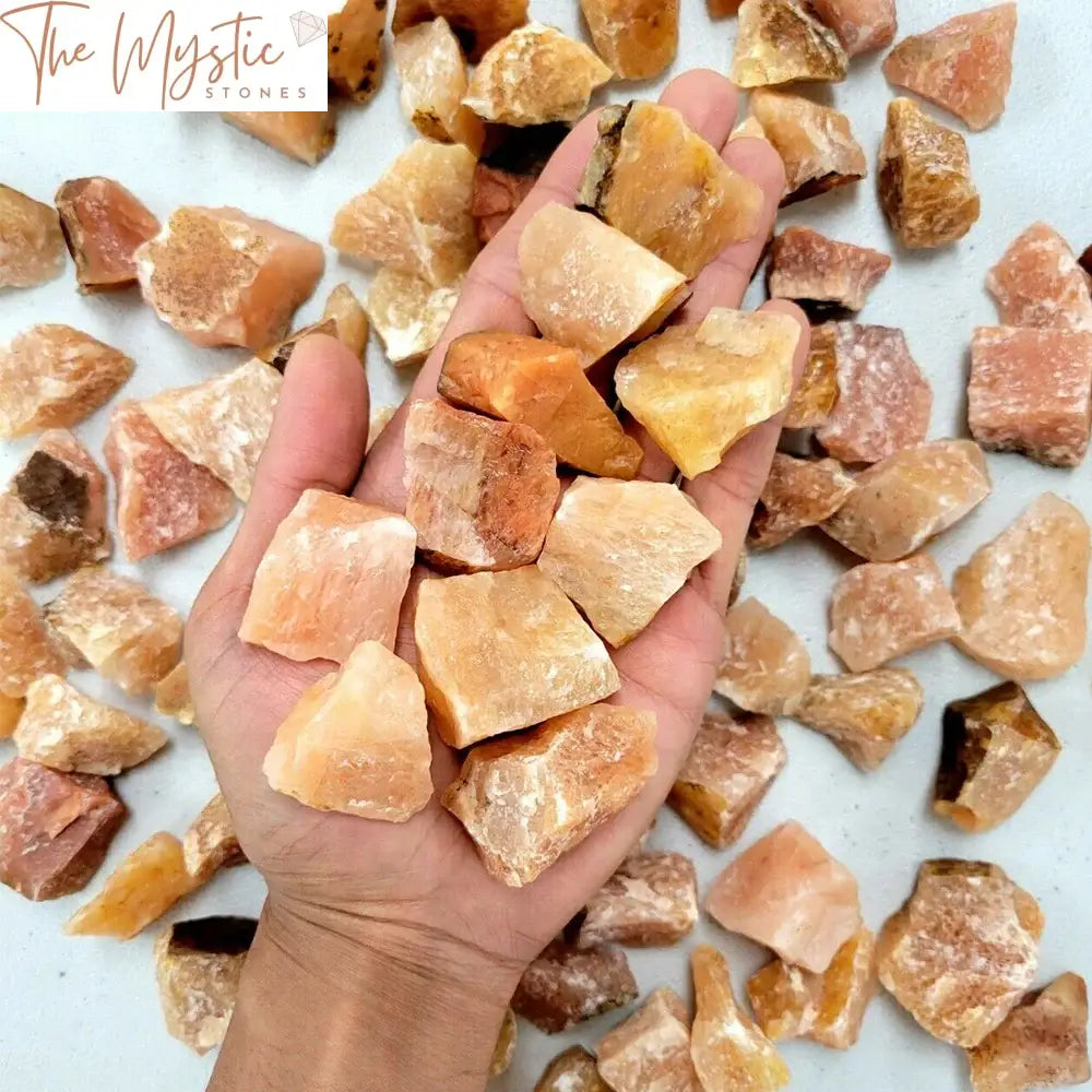 A pile of raw red aventurine crystals with irregular shapes and rough surfaces, showcasing their natural reddish-brown hues.