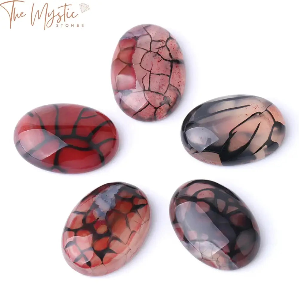 A collection of oval-shaped Red Dragon Veins cabochon beads in varying sizes placed on a neutral background.