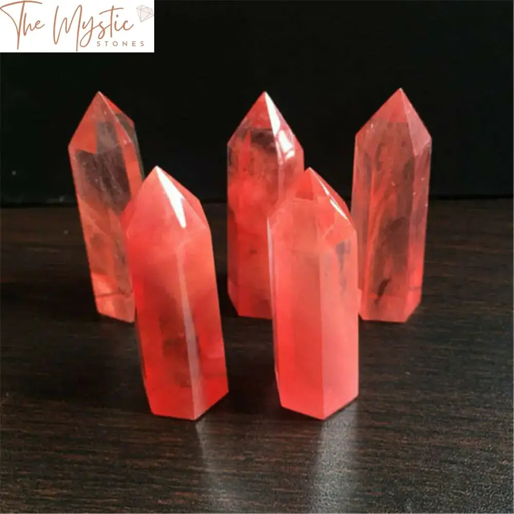 A close-up image of a red smelting quartz crystal, shaped as a hexagonal obelisk wand.