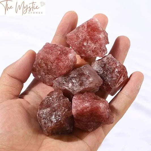 A collection of natural red strawberry quartz rough stones with various textures and shapes, showcasing their mineral beauty.