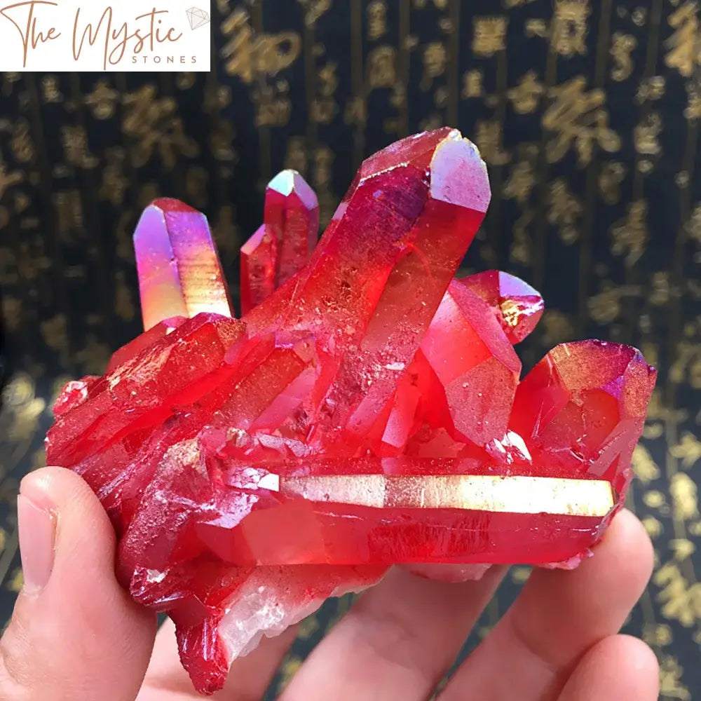 A vibrant cluster of red titanium-coated quartz crystals with sharp, glistening points, forming a stunning geode.