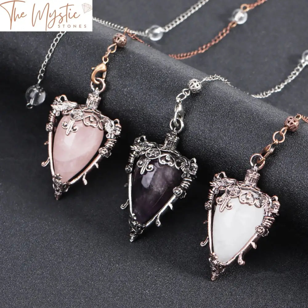 A pink quartz pendulum with a teardrop-shaped crystal at the end, hanging from a delicate silver chain.