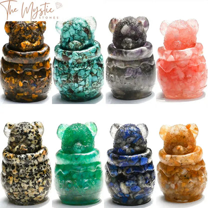 A 2-inch resin bear figurine holding a honey pot, surrounded by natural healing crystals.